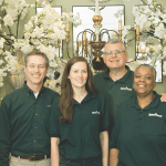 Tipton and Hurst team members in dark green shirts